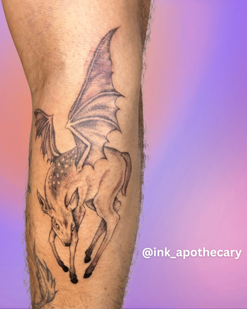 Fine line fantasy dragon tattoo with wings on forearm in black and grey ink
